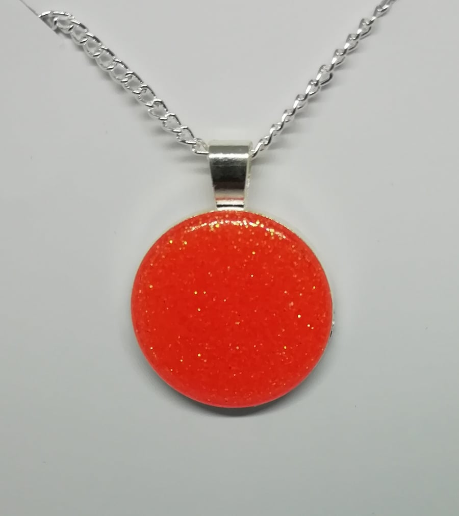 Round orange glittered epoxy pendant 