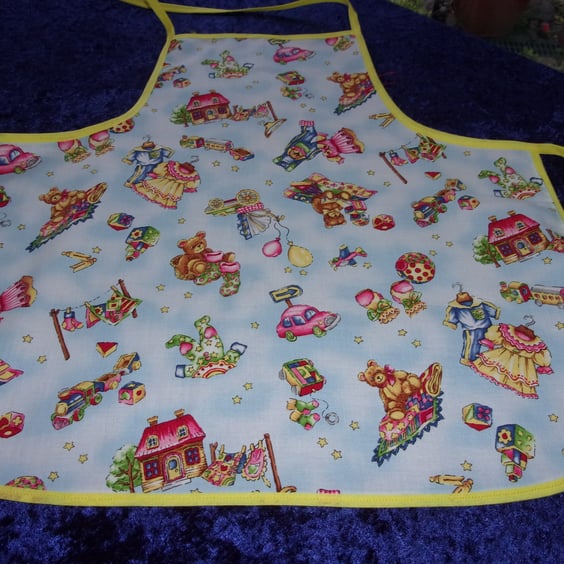 Toys on a pale blue background Baby Apron