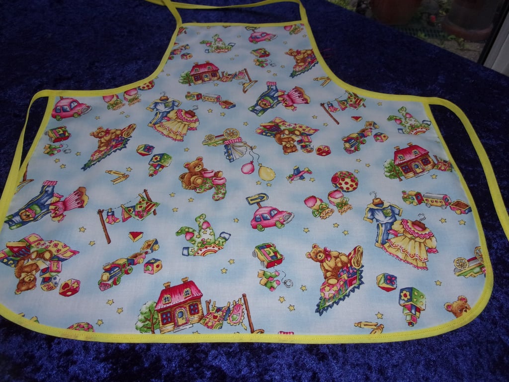 Toys on a pale blue background Baby Apron