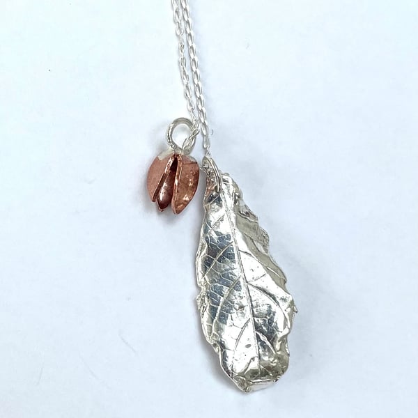 Silver leaf pendant with copper seed pod