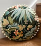 Round feature cushion in vintage leafy linen with pompoms - Image 7