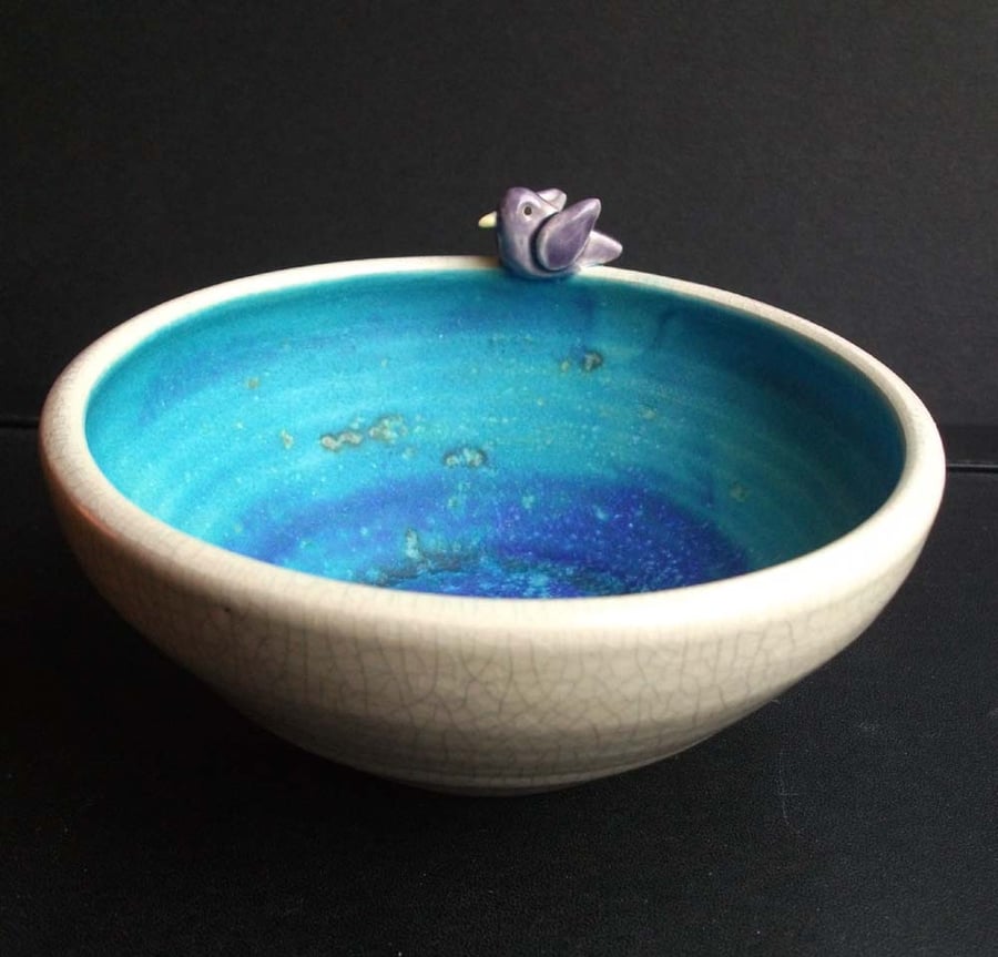 Small ceramic hand thrown crackle bowl with sea glaze interior and purple bird