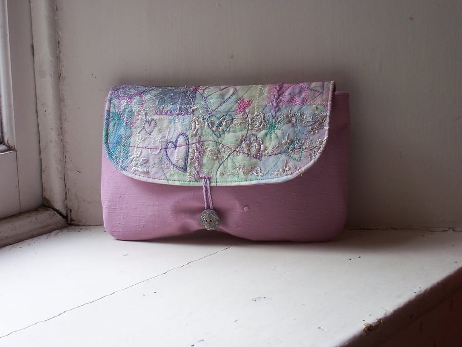 Hand and machine embroidered fabric clutch bag