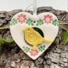 Small Ceramic bird in a heart decoration yellow bird