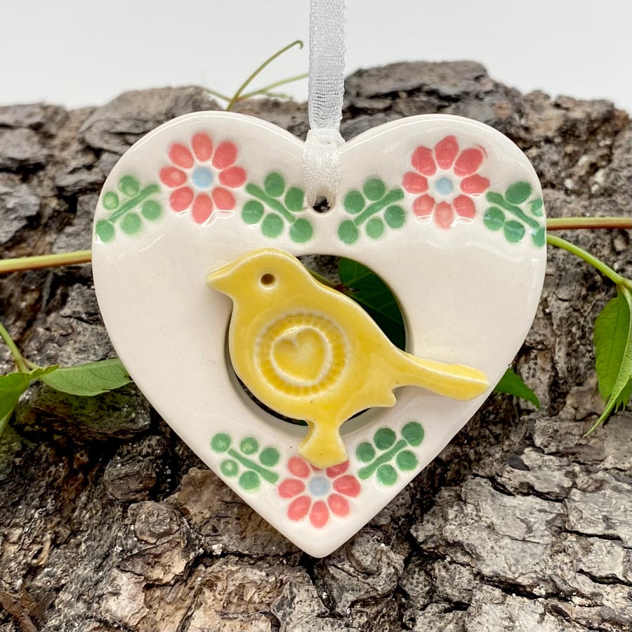 Small Ceramic bird in a heart decoration yellow bird