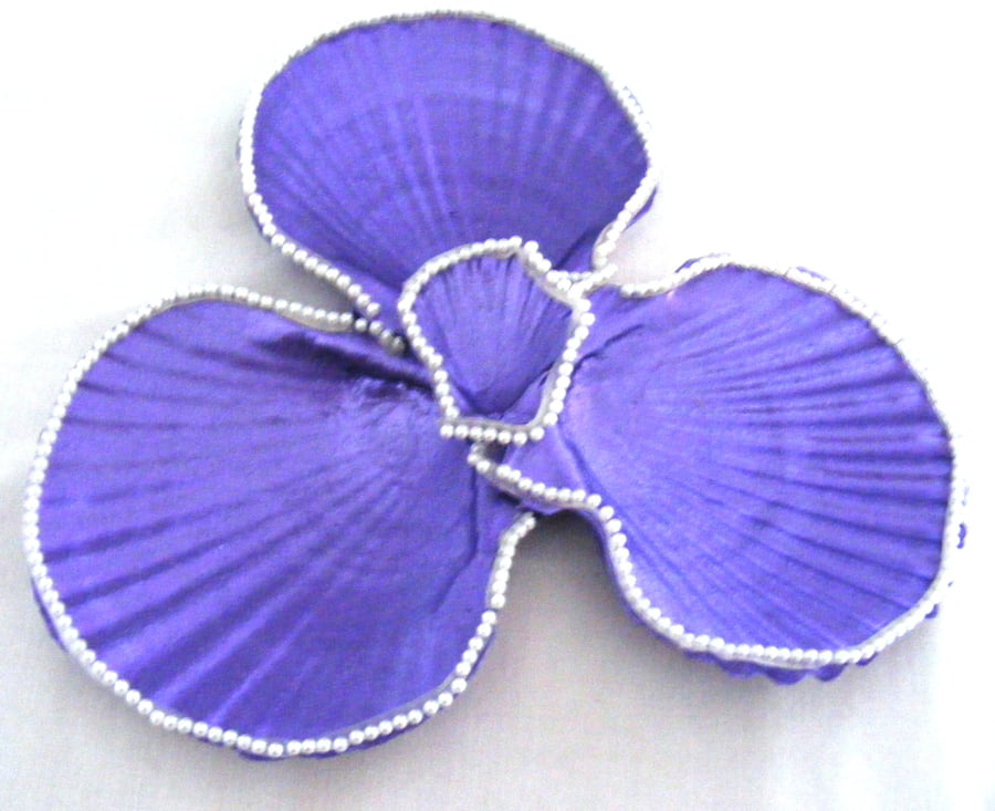 Metallic purple scallop shell trinket dish with pearl trim.