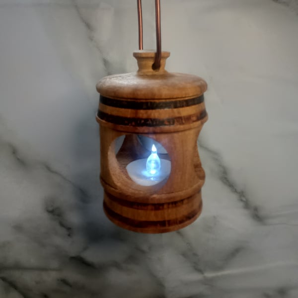 Handmade Iroko African Teak lantern, with a battery operated tea light.