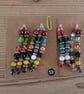 Set of colour coordinated beaded gift decorations. - Image 4