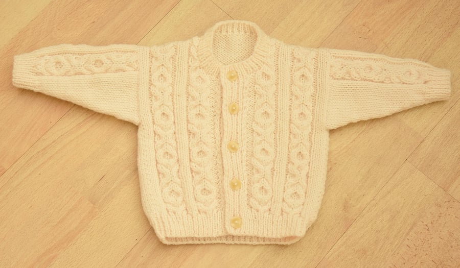 baby cardigan hand knitted in an aran style tofit age6 to 12 months