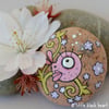 pink bird and blossom on a curly branch - pebble art
