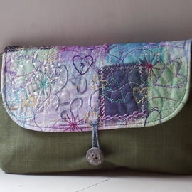 Textile art clutch bag with button and loop fastening 