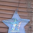 Hanging clear resin star with multicoloured dichroic strips