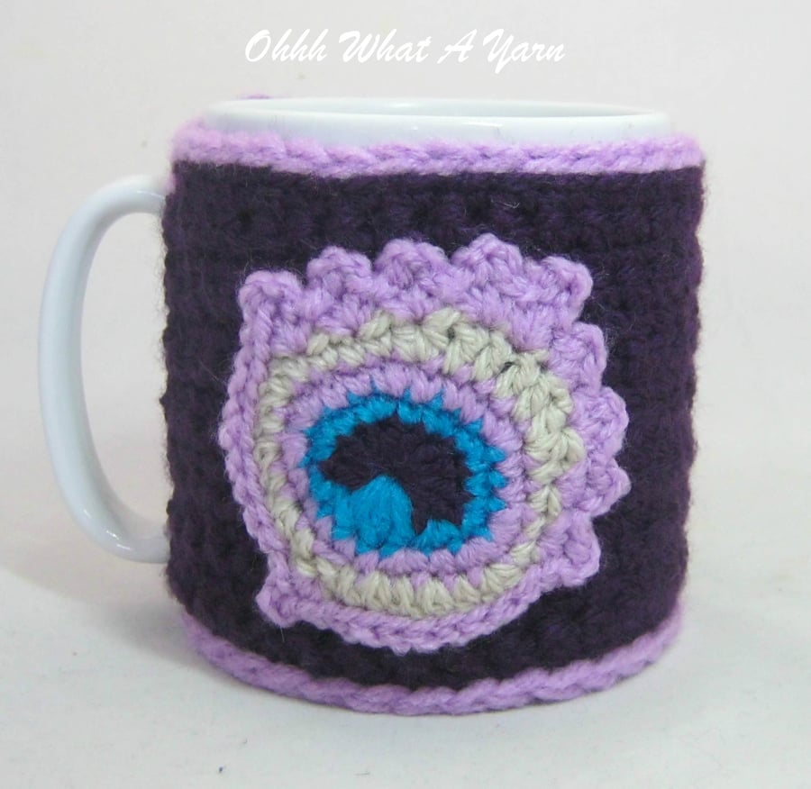 Crochet purple peacock feather mug cosy, mug hug.