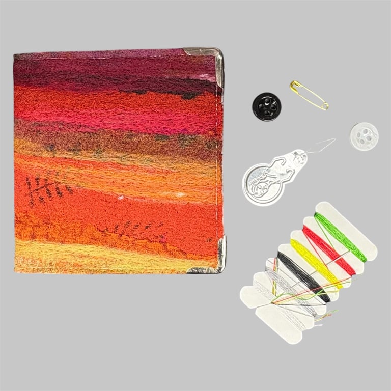 Needle case, book, needle felted silk and wool in shades of red and orange