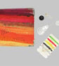 Needle case, book, needle felted silk and wool in shades of red and orange