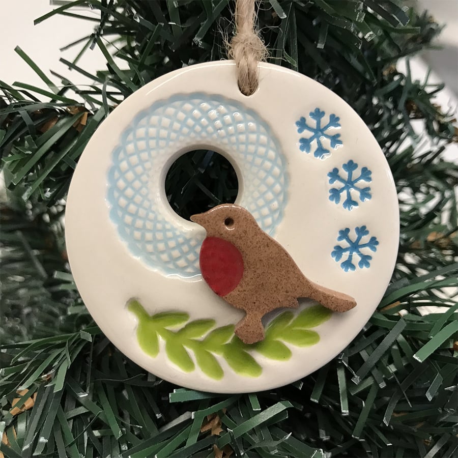 Ceramic Christmas decoration with robin on a branch