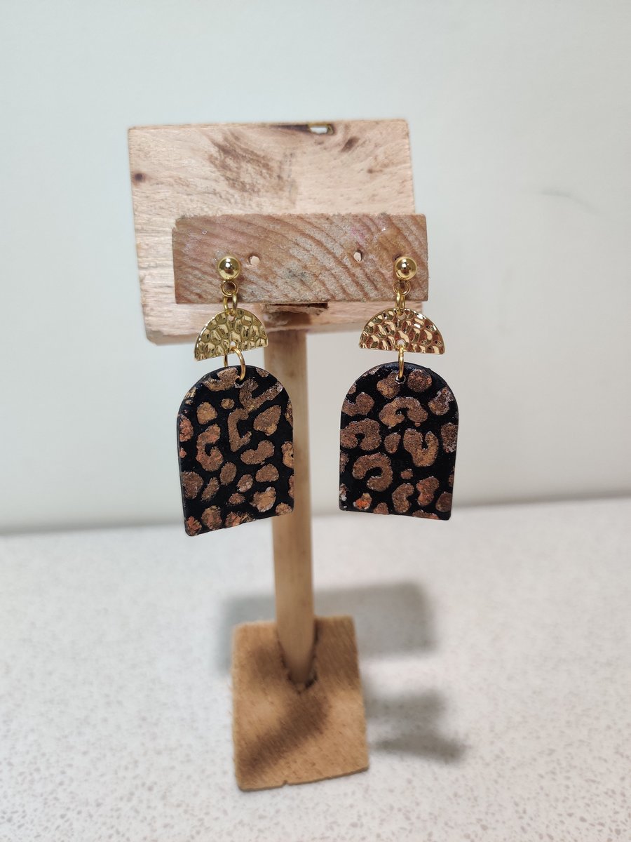 Black and gold leopard arch dangle earrings