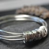 Three bangles with 21 ring charm 