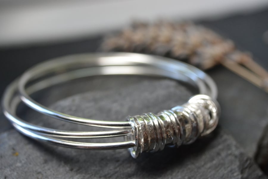 Three bangles with 21 ring charm 