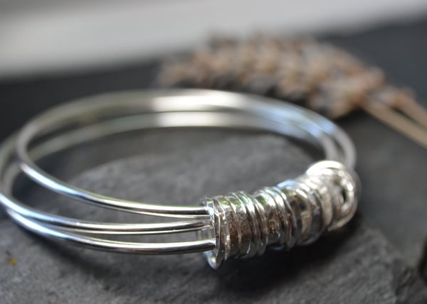 Three bangles with 21 ring charm 