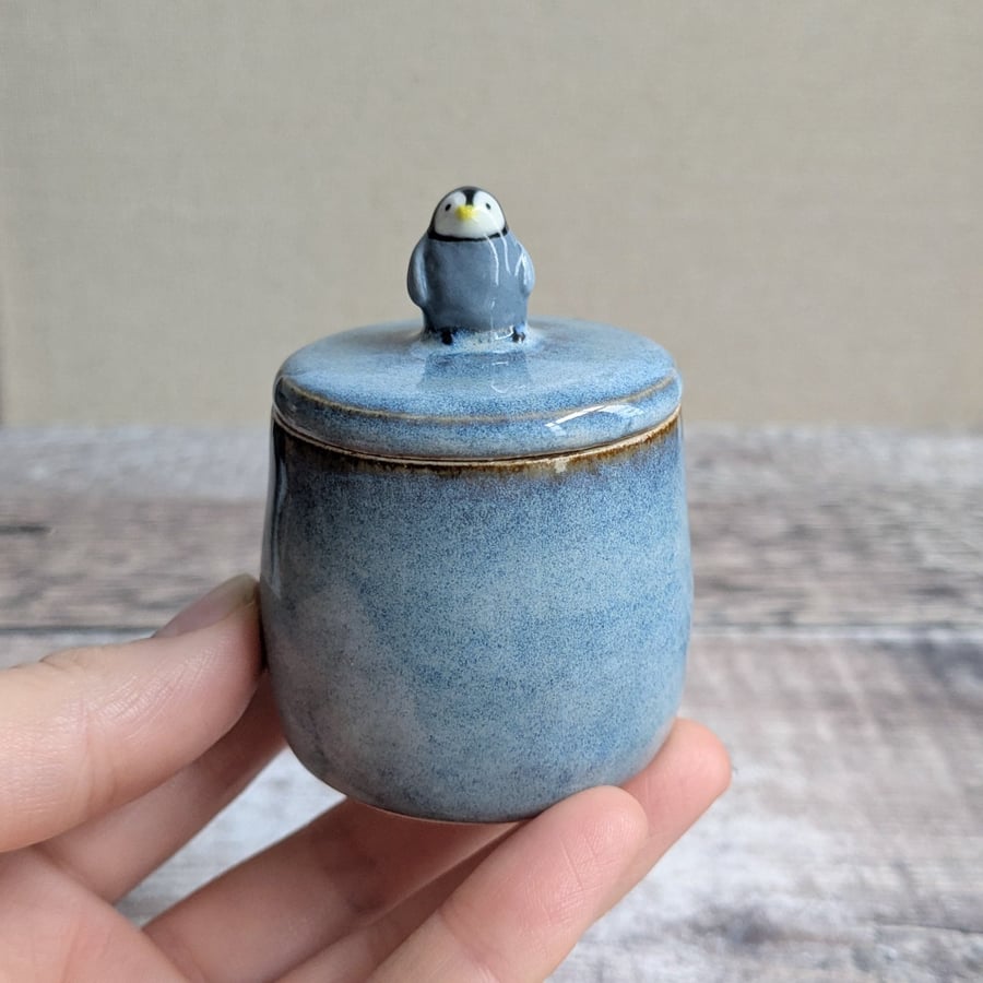 Small handmade ceramic lidded pot with baby penguin, blue glaze