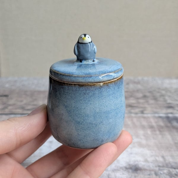 Small handmade ceramic lidded pot with baby penguin, blue glaze