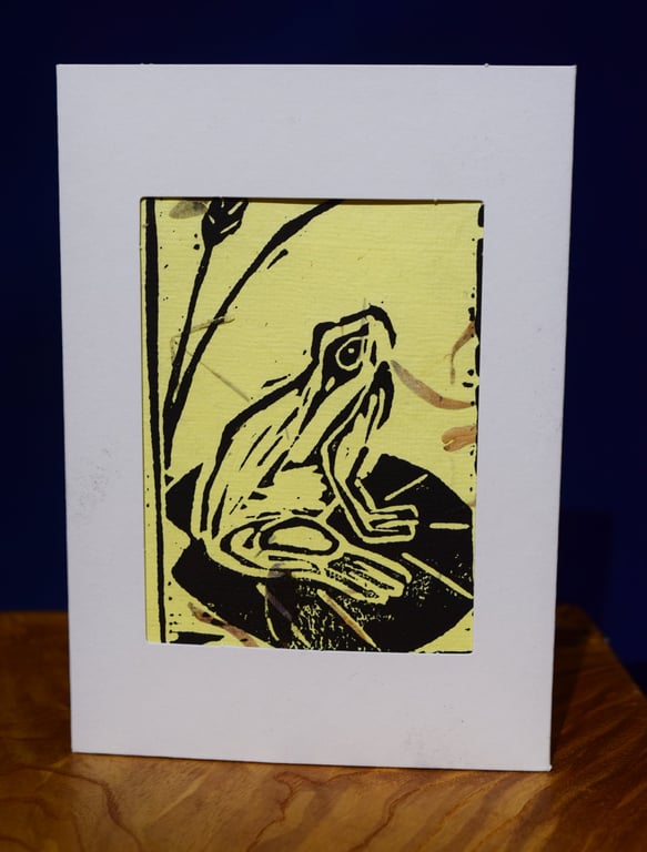 Lino print Frog on yellow paper with petal texture