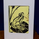 Lino print Frog on yellow paper with petal texture