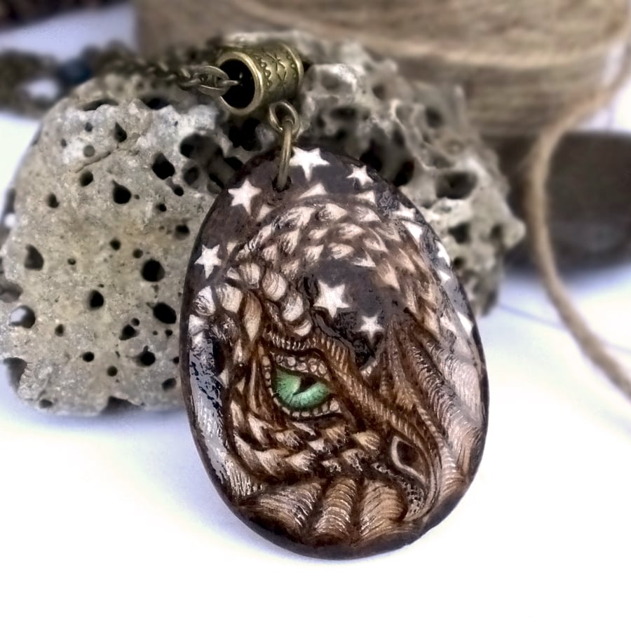 Green eyed dragon. Pyrography wooden teardrop pendant for a dragon lover.