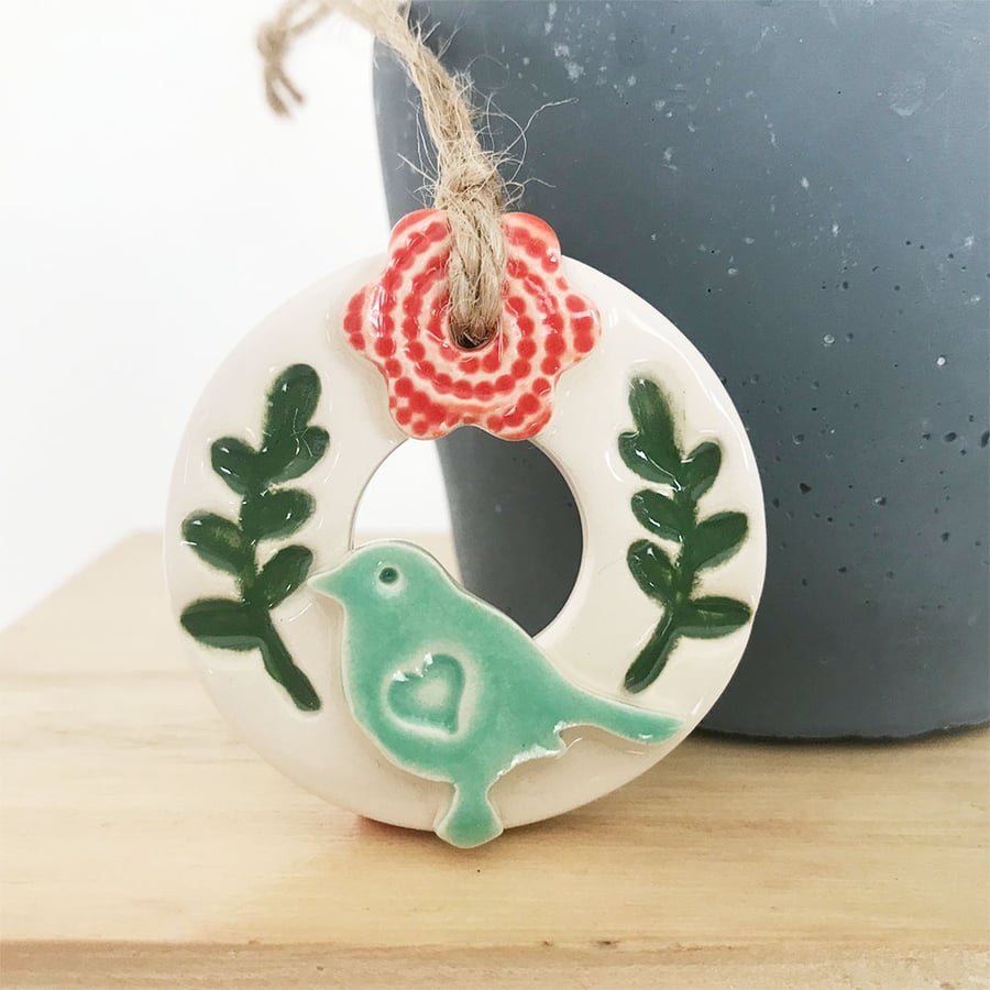 Teeny bird and flower wreath pottery decoration