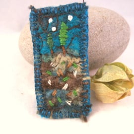 Hand embroidered needlefelt brooch with trees and stars