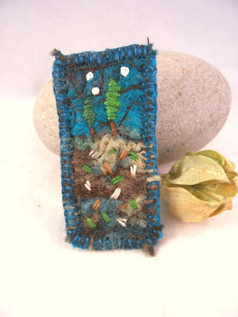 Hand embroidered needlefelt brooch with trees and stars