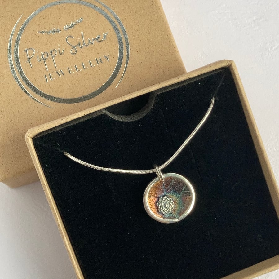 Silver concave leaf imprint pendant necklace with flower detail