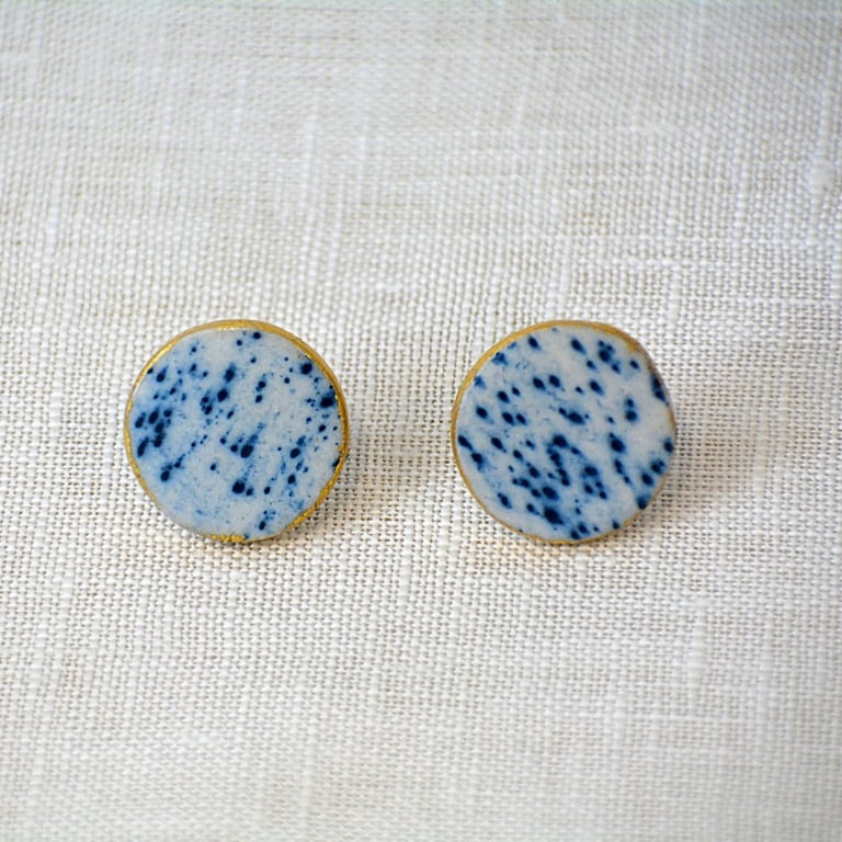 Round porcleain earrings with blue detail and edged with gold leaf