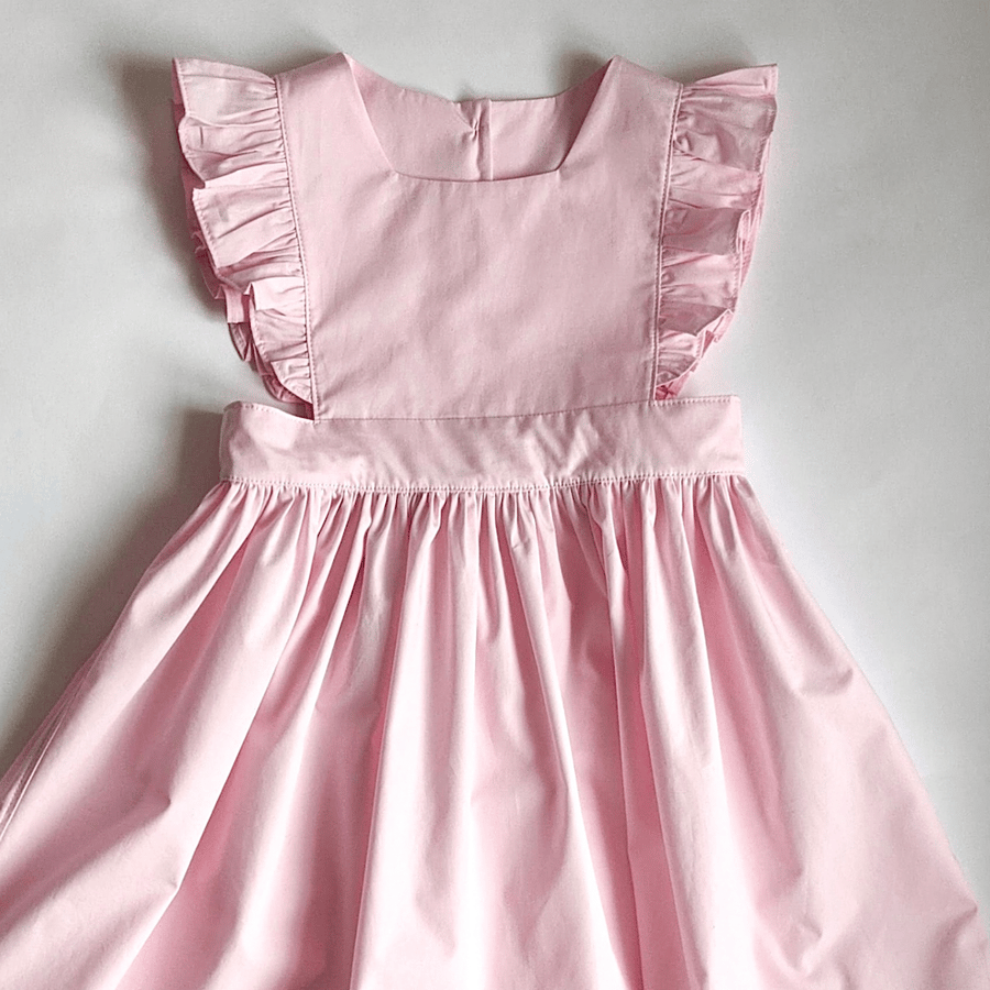 Baby girl pink dress. Light pink flutter sleeve pinafore for babies & toddlers.