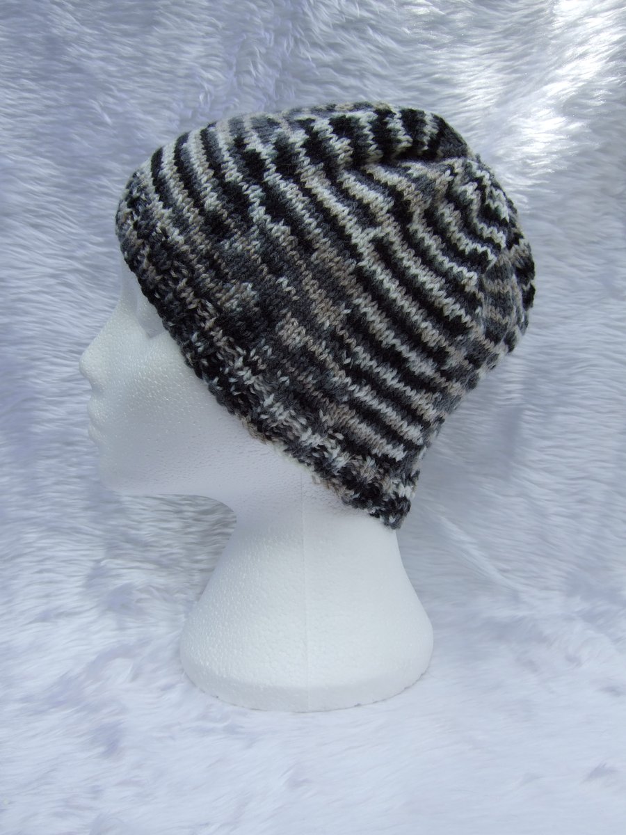Hand knitted beanie hat in black and cream for children or teenagers
