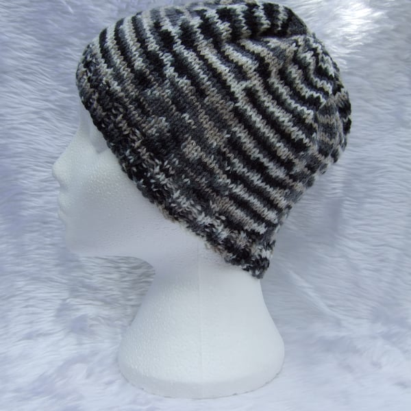 Hand knitted beanie hat in black and cream for children or teenagers