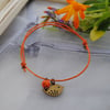 Friendship Bracelet-Orange with copper bird 