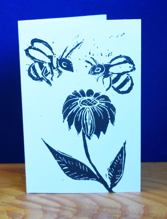 Bees on a flower - Lino print, black ink on white card.