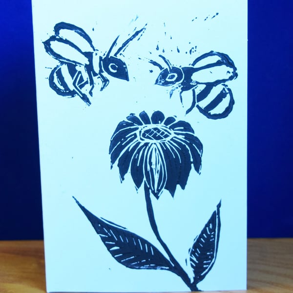 Bees on a flower - Lino print, black ink on white card.