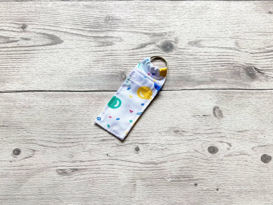 Balloons lip balm white polycotton fabric keyring. 