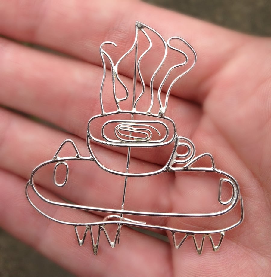 A personalised silver brooch made from a childs drawing. 