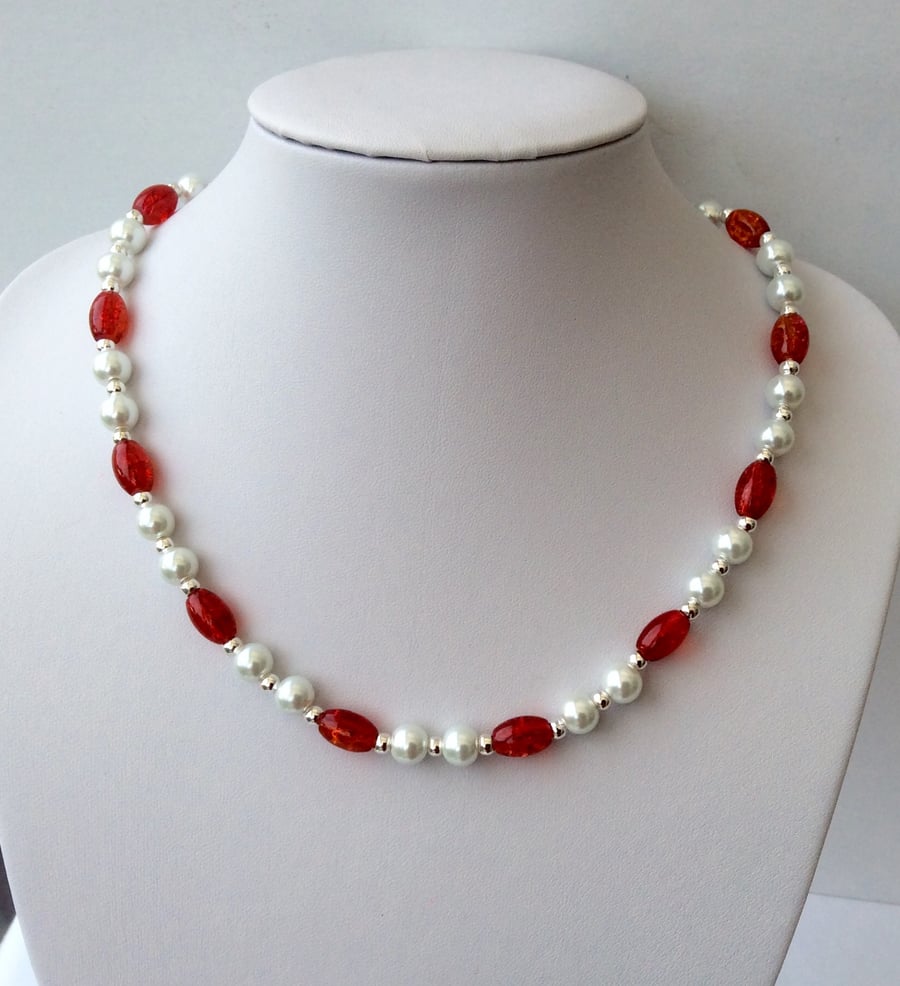 White glass pearl and oval red-orange crackle glass bead necklace.