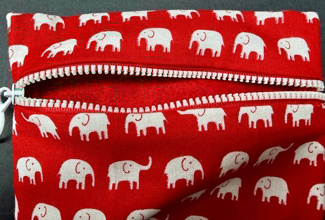 Small funky zipped pouch with white elephants on scarlet red background
