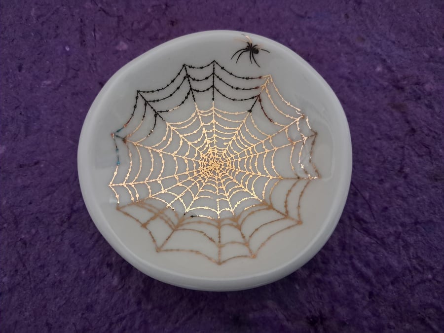 Small porcelain dish with a gold spider's web