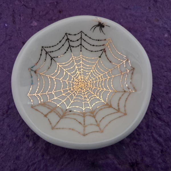 Small porcelain dish with a gold spider's web