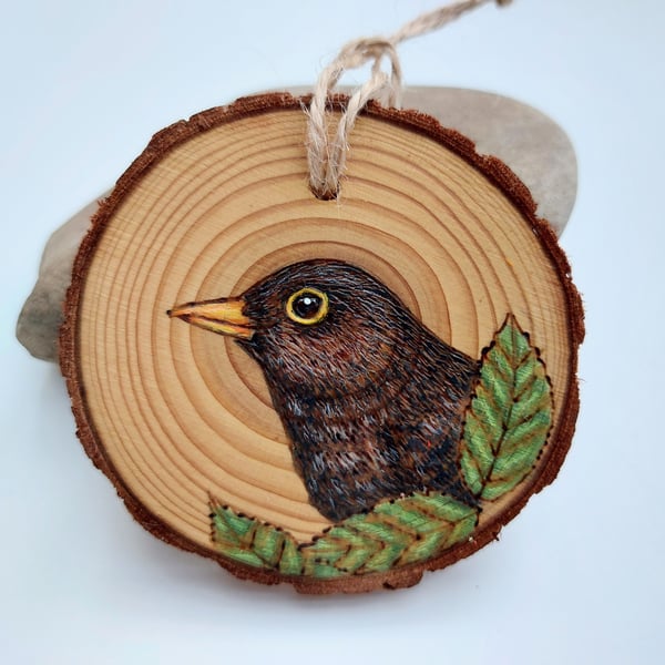 Blackbird pyrography log slice decoration