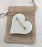 Handmade heart brooch crafted from smooth jesmonite and red aluminium pieces - Image 2
