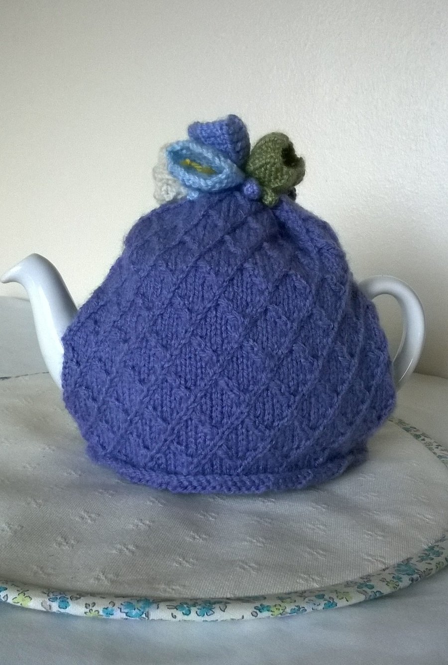 Hand knitted lavender tea cosie with crocus flowers