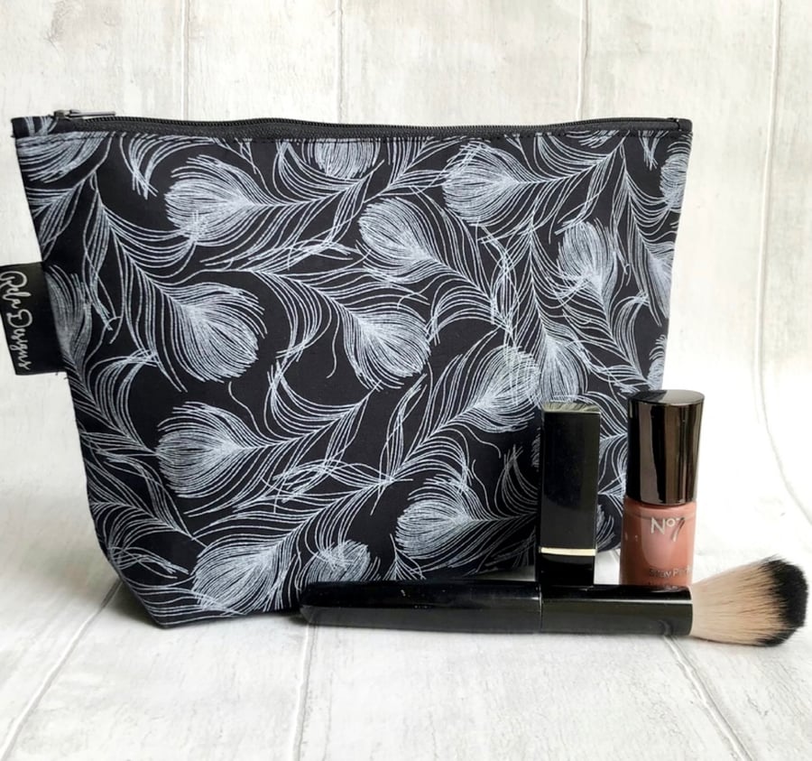 Makeup bags, black feathers